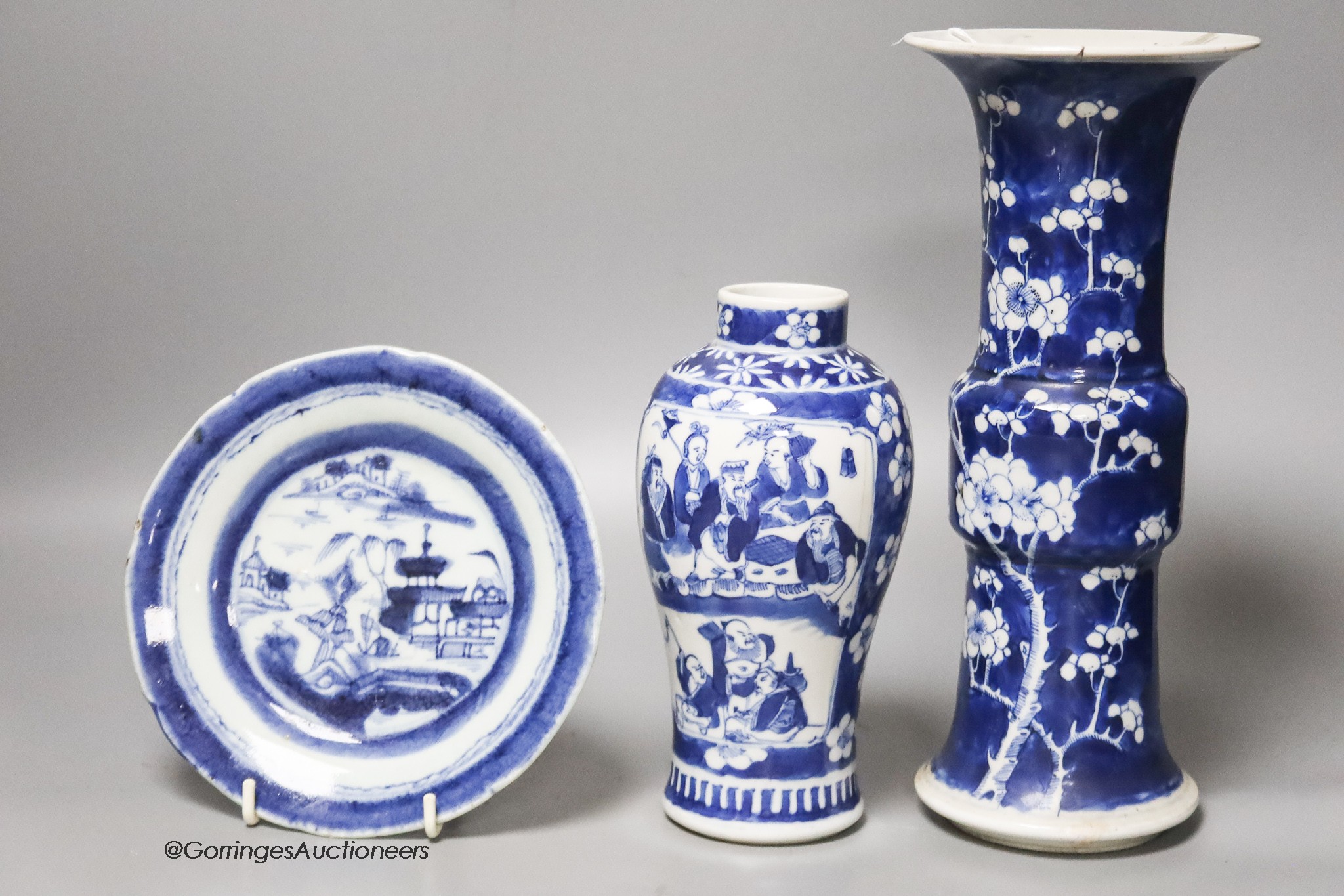 A Chinese blue and white gu vase, a baluster vase and a dish, tallest 26cm